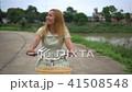 Young woman with bicycle walking on the park 41508548