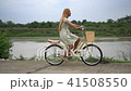 Young woman with bicycle walking on the park 41508550