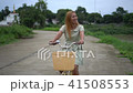 Young woman with bicycle walking on the park 41508553