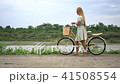 Young woman with bicycle walking on the park 41508554