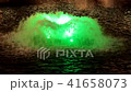 Fountain in the pond with green light at night. 41658073