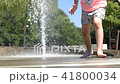 Girls leg and feet wet in fountain 41800034