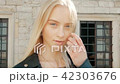 fashion portrait of a beautiful young woman with blue eyes and blonde hair in a leather jacket 42303676