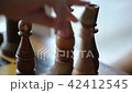 Close-up chess game. Bishop moving, Rook falling 42412545