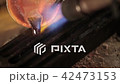 Pouring molten silver into a mold 42473153