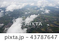 Aerial view of clouds through airplane window 43787647