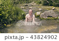 Smiling man dipping and bathing in cold river water at summer day. Slow motion 43824902