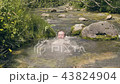 Happy man dipped and splash of water from mountain spring. Man bathing in river 43824904