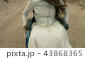 Disabled rides in a wheelchair along the beach 43868365