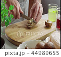 Cutting mushrooms on cutting board 44989655