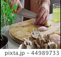 Chopping shallot on cutting board 44989733