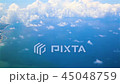 Traveling by air above clouds. View through an airplane window. Flying over the Atlantic Ocean. 45048759
