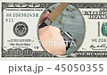 Fishing reel closeup in frame of 100 dollar bill 45050355