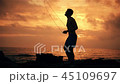 Silhouette of man exercising with a skipping rope on sunset background at ocean 45109697