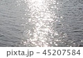 A strip of sunlight on a moving wavy water surface 45207584
