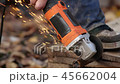 Worker cuts the metal structure with a machine. 45662004