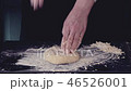 Female hands making dough for pasta over black 46526001