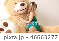 Happy beautiful girl hug huge teddy bear 46663277