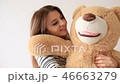Pretty beautiful lady hug big teddy bear 46663279
