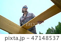 the worker is building the roof 47148537