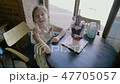 A little curious girl rejoices at a delicious unusual dessert 47705057