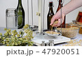 Home brewing of beer. Man weighs barley. 47920051