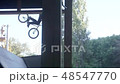 Cyclist doing a flip in jump 48547770