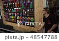 Man throws bicycle accessories to another man in the shop 48547788