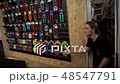 Man throws spare parts for a bicycle to another man and he catches them 48547791