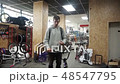 Man at the sports store explains something and laugh 48547795