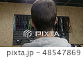 Man stands in the store and looks at the parts for the bike 48547869