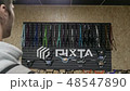 Man stand in the store and looks at the parts for bicycles 48547890