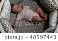 Newborn baby. Little baby. Child. Adorable baby girl. Baby in crib. Baby in bed 48597443