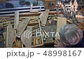 Wood carver is carving an oak plank with chisel. 48998167