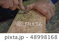 Close up shot of wood carver's hands. 48998168