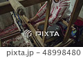 Weaver who is weaving a traditional belt. 48998480