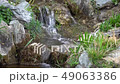 Flowing water stream, water drops and reflection 49063386