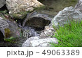 Slow motion Flowing water stream, water drops and reflection 49063389