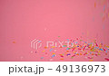 colorful sprinkles falling on pink background 49136973