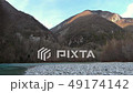 Mature hiker on the bank of a river. 49174142