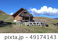 Mature hiker arrives at a public alpine hut. 49174143