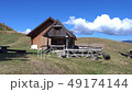 Mature hiker arrives at a public alpine hut.  49174144