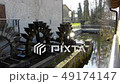 Wooden waterwheel in action of water mill 49174147
