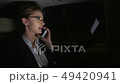 businesswoman in the car talking on the phone. She rides in the car on the night road. 49420941