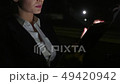 Businesswoman in the car uses a tablet for work. She rides in the car on the night road. 49420942