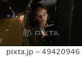 Businesswoman in the car uses a tablet for work. She rides in the car on the night road. 49420946