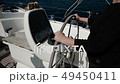 Woman's Hands on the Wheel of Sailing Yacht. FullHD 49450411