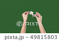 Green screen. Chromakey. Woman hands breaks the hundred dollar bill. 49815803