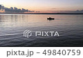 Father and son in a rowboat. Silhouettes of two people boating at sunset. 49840759