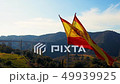 Teared up Spanish flag waving in slow motion 49939925